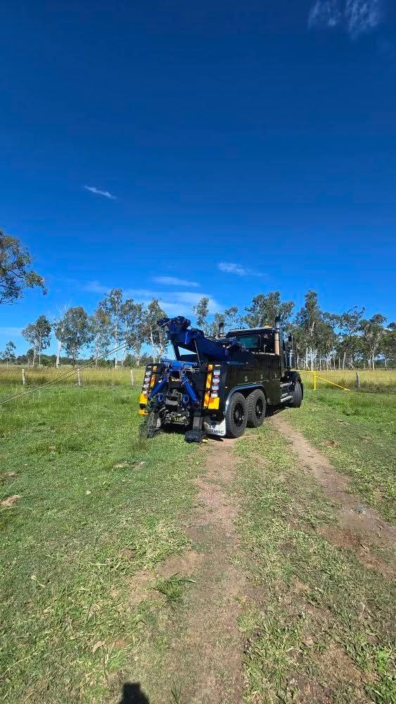 Black Tow Truck on a Dirt Track in a Grassy Field — GTS - Gardiner Transport Solutions in Berserker, QLD