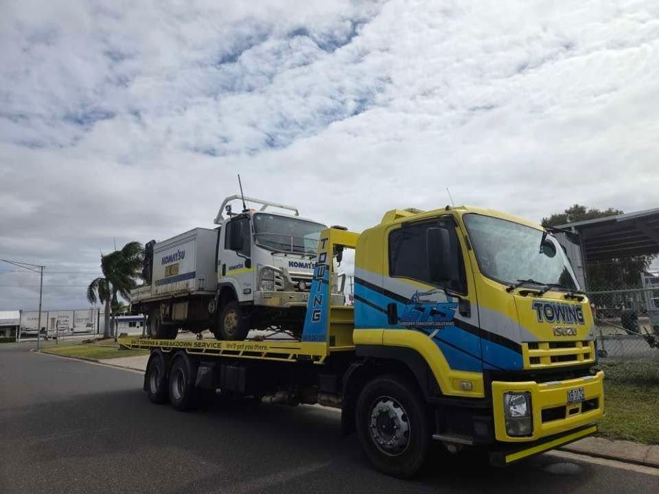 Yellow Tow Truck Carrying a White Truck on a Sunny Day — GTS - Gardiner Transport Solutions in Berserker, QLD