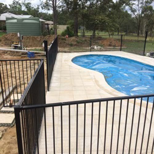 pool with a fence behind it