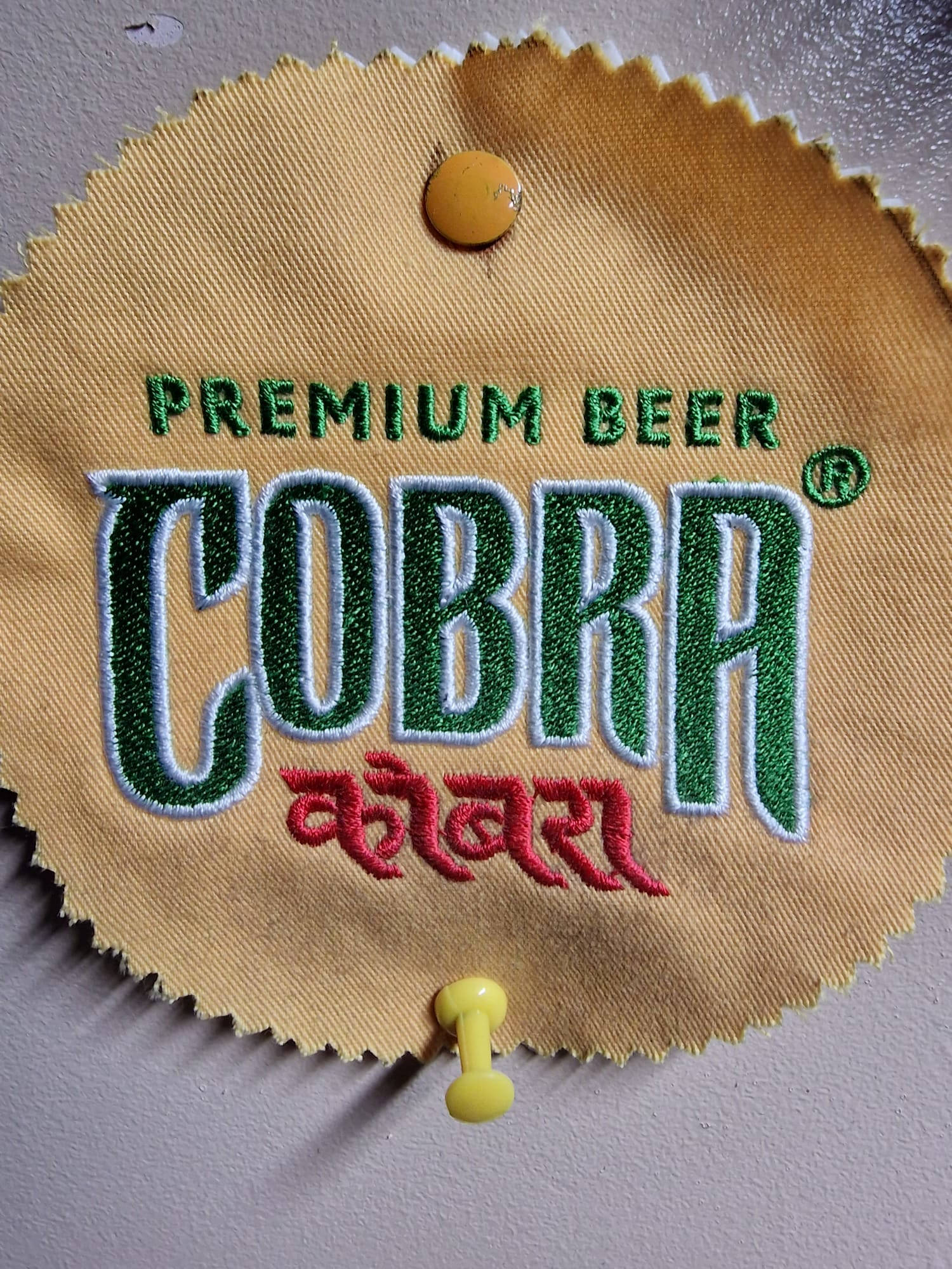 Embroidered Cobra beer logo,