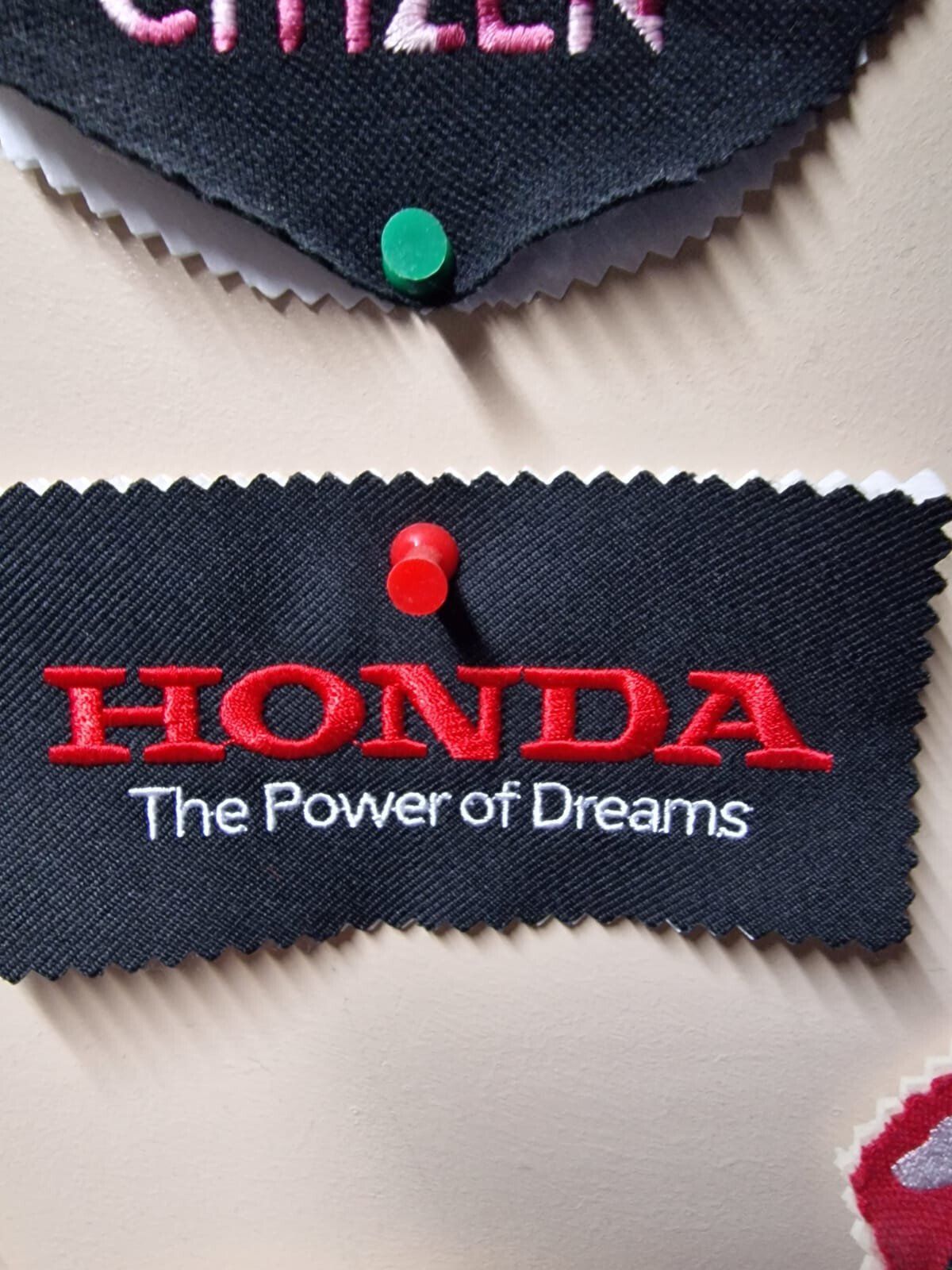 Embroidered Honda logo on a black fabric, red text, with the tagline