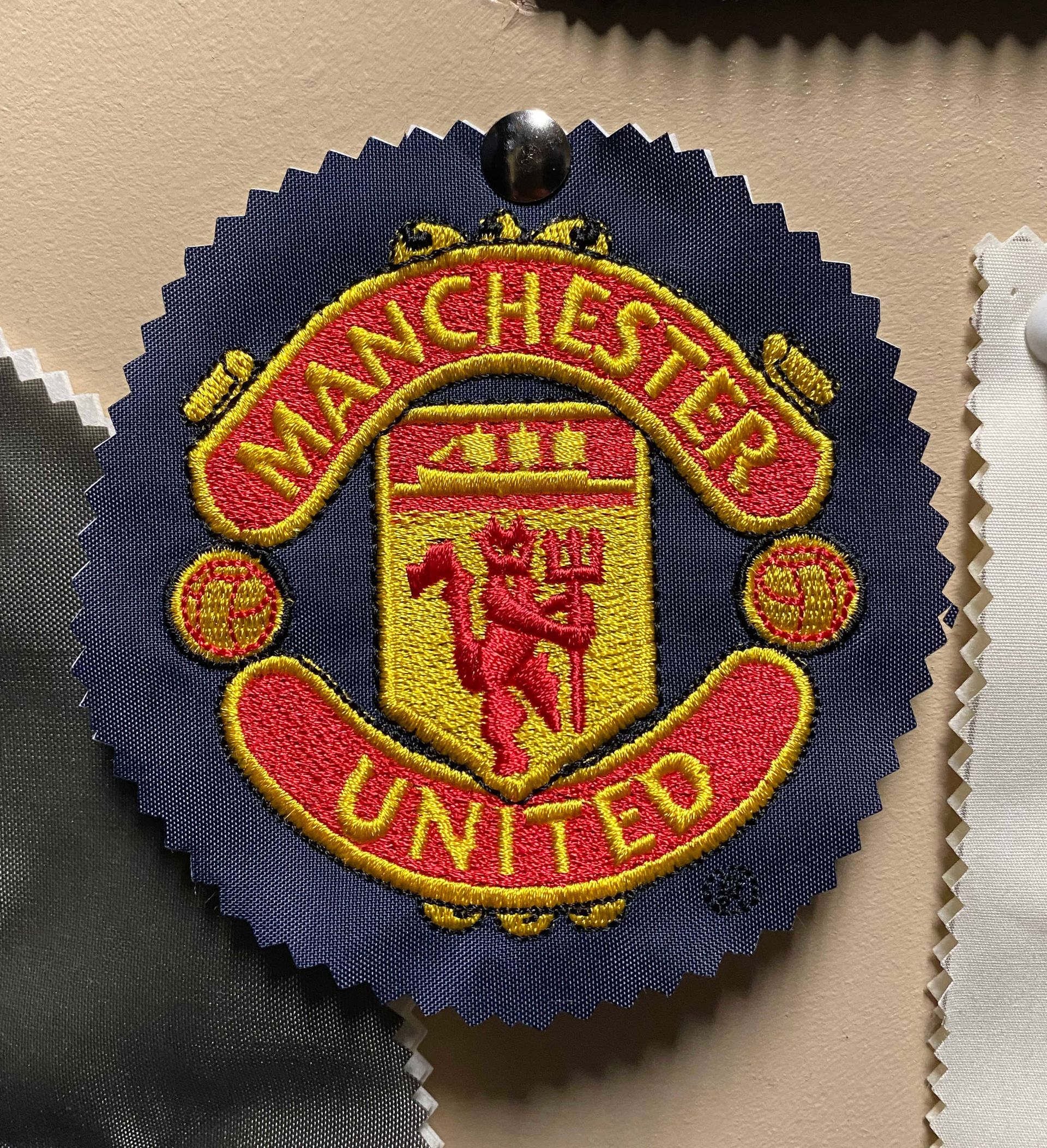 A manchester united patch is on a piece of fabric