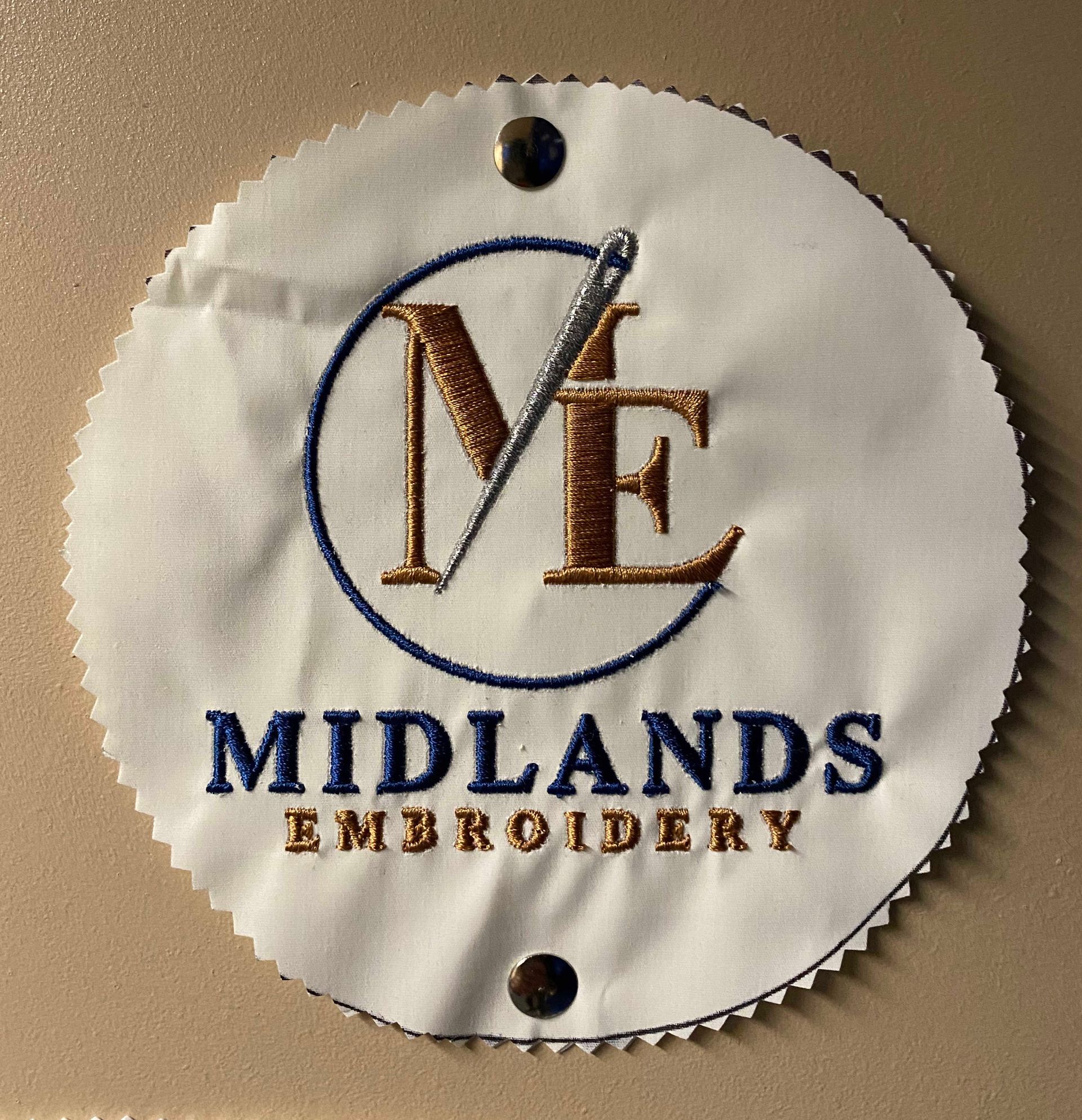 Circular white embroidered patch with