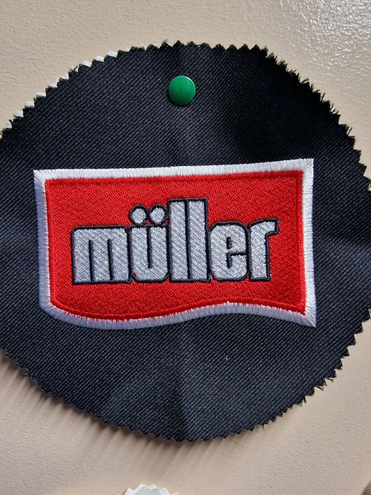 Black fabric swatch with a red rectangle embroidered with