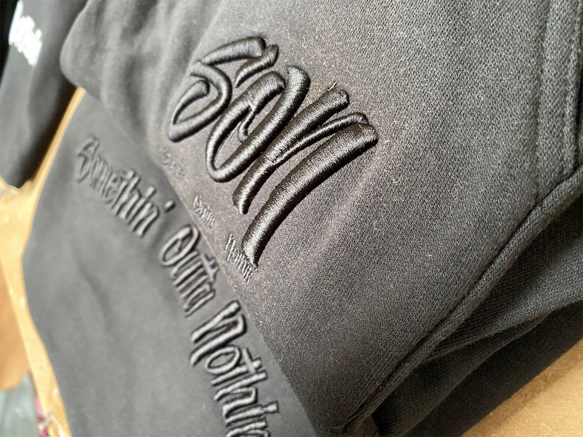 Black sweatshirt with 3D raised embroidery of