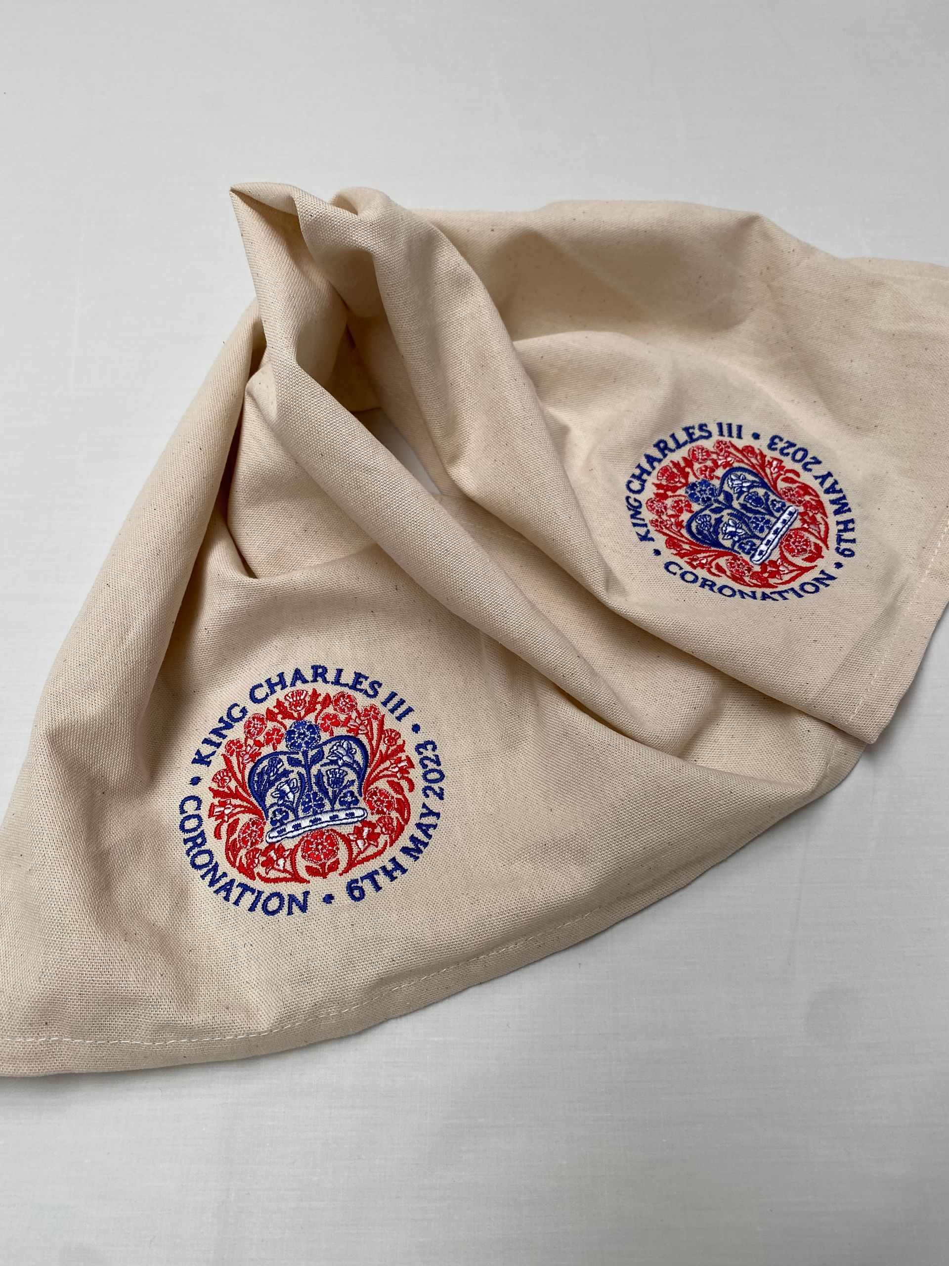 Embroidered Coronation emblem, featuring red, blue, and white detailing; reads
