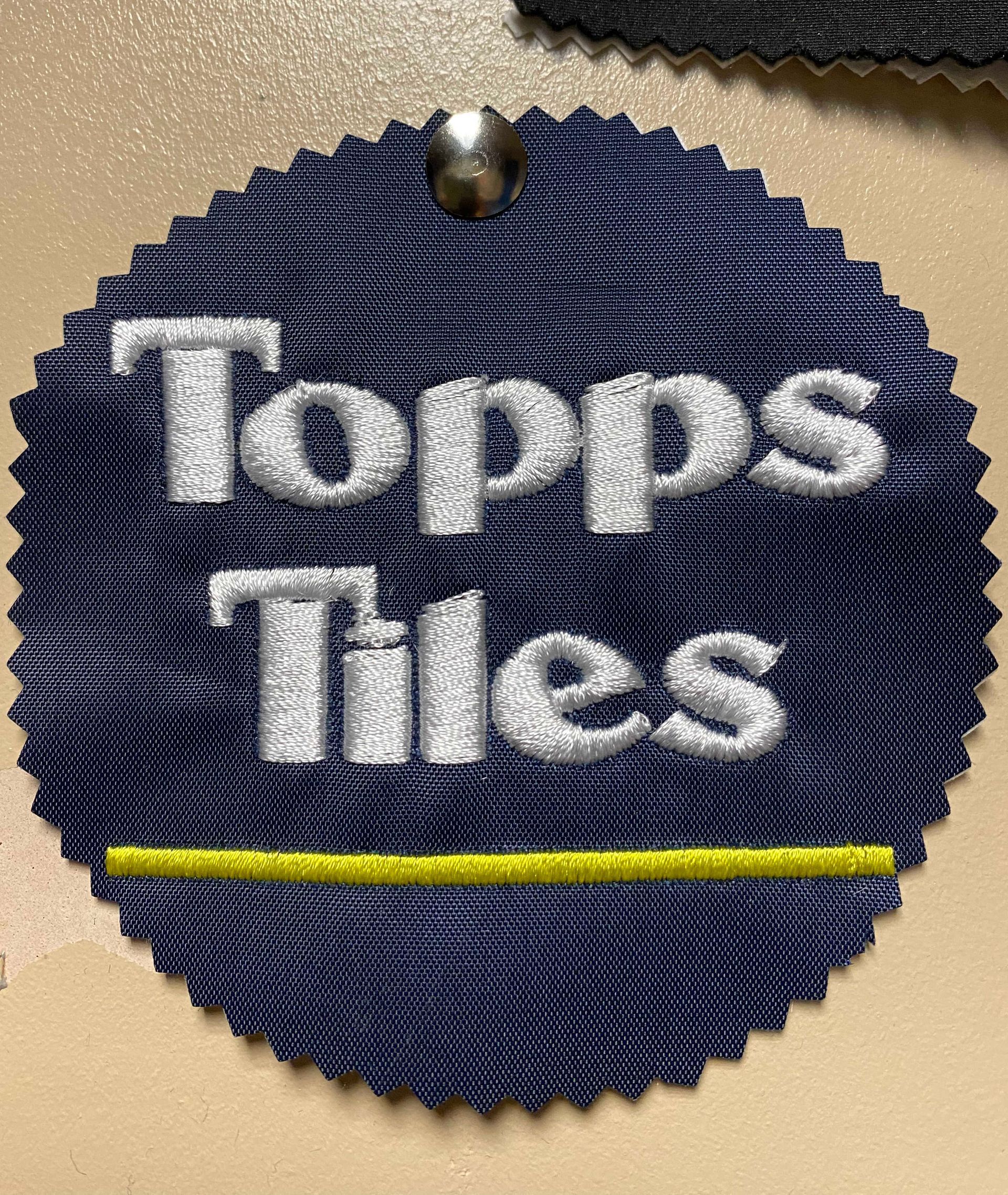 Navy blue fabric tag with the words