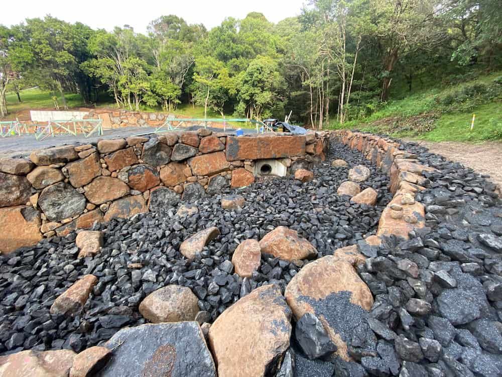 A Pile Of Rocks In A Circle With Trees In The Background — J & M Bashforth & Sons In Brunswick Heads, NSW