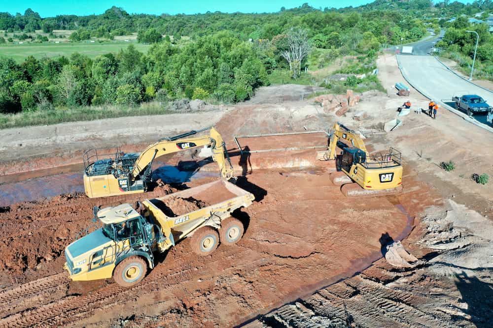 A Group Of Construction Vehicles Are Working On A Dirt Road — J & M Bashforth & Sons In Brunswick Heads, NSW