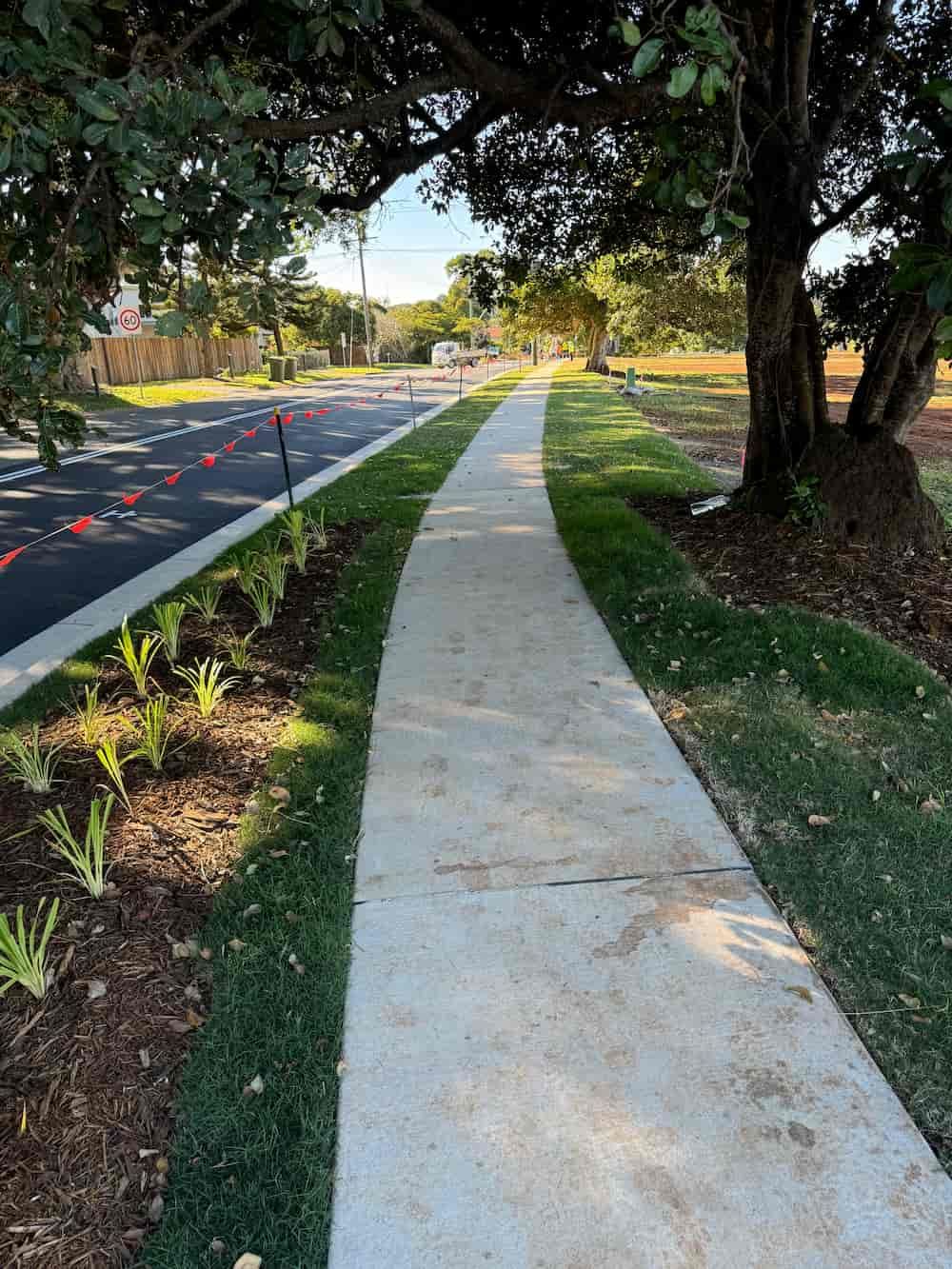 A Sidewalk Leading To A Road With Trees On The Side Of It — J & M Bashforth & Sons In Brunswick Heads, NSW