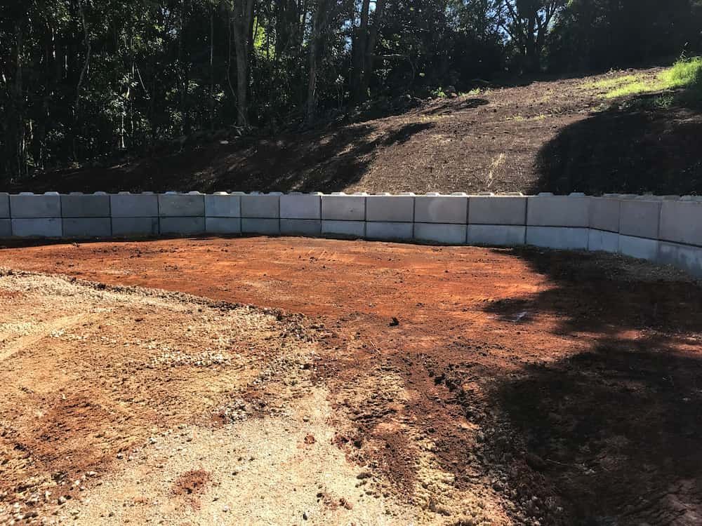 A Dirt Field With A Concrete Wall Surrounding It — J & M Bashforth & Sons In Brunswick Heads, NSW