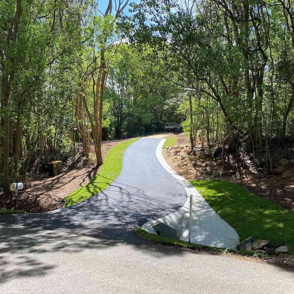 A Curvy Road Going Through A Forest With Trees On Both Sides — J & M Bashforth & Sons In Brunswick Heads, NSW