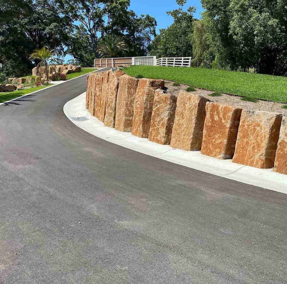 A Road With A Stone Wall On The Side Of It — J & M Bashforth & Sons In Brunswick Heads, NSW