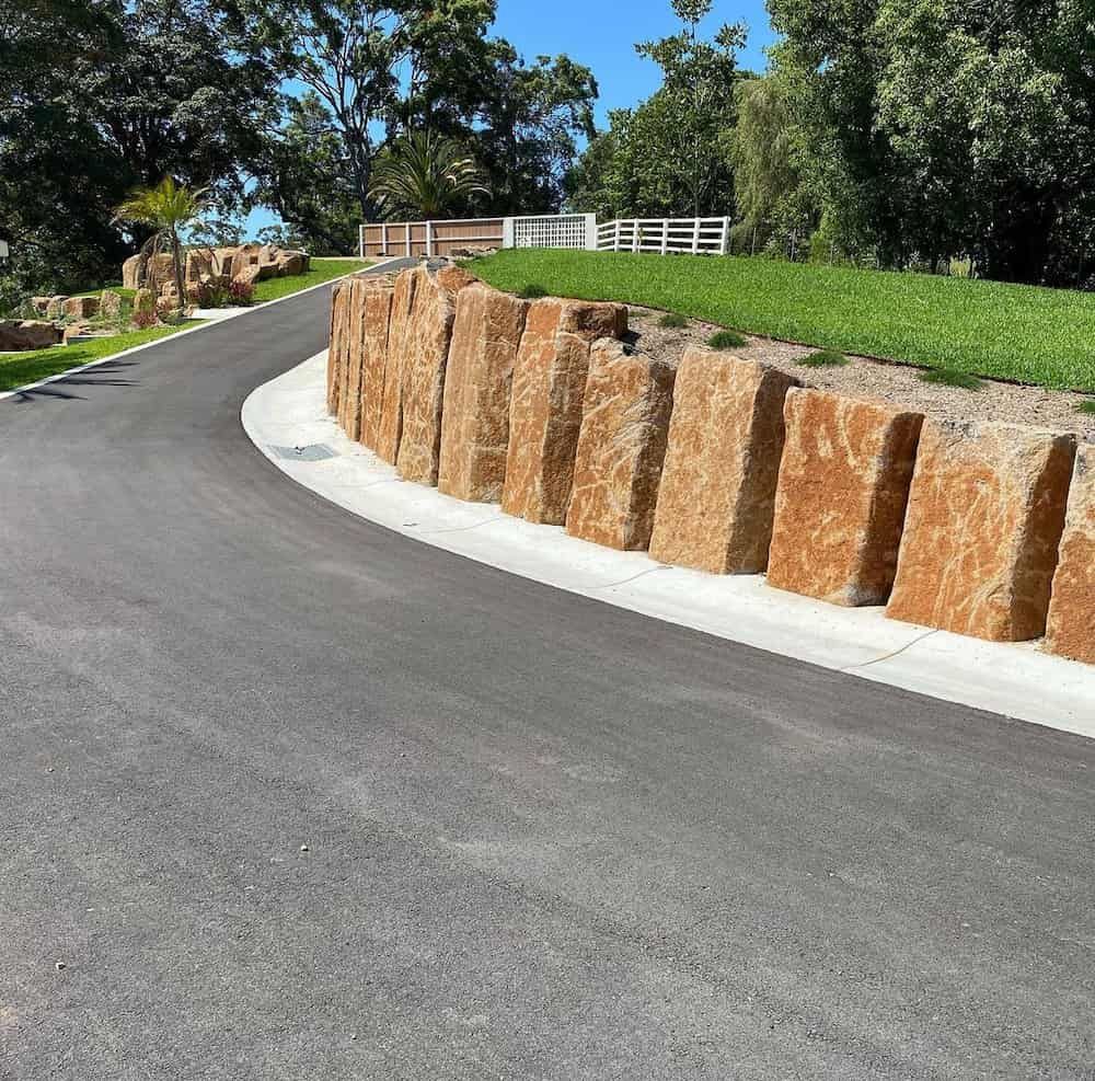 A Road with A Stone Wall on The Side of It — J & M Bashforth & Sons In Yamba, NSW