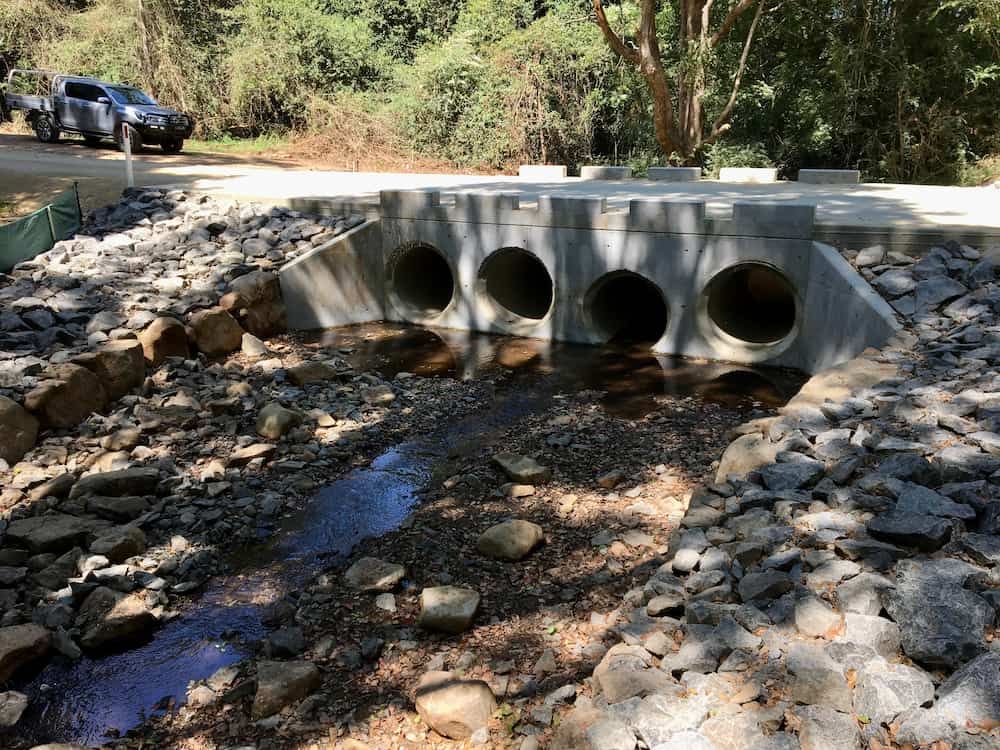 A Bridge Over A Stream Surrounded By Rocks And Trees — J & M Bashforth & Sons In Brunswick Heads, NSW