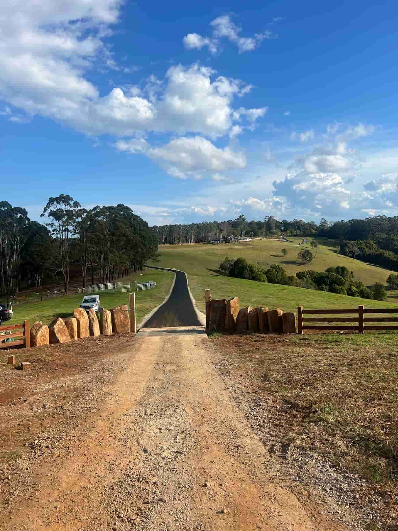 A Dirt Road Going Through A Field With A Wooden Fence — J & M Bashforth & Sons In Brunswick Heads, NSW