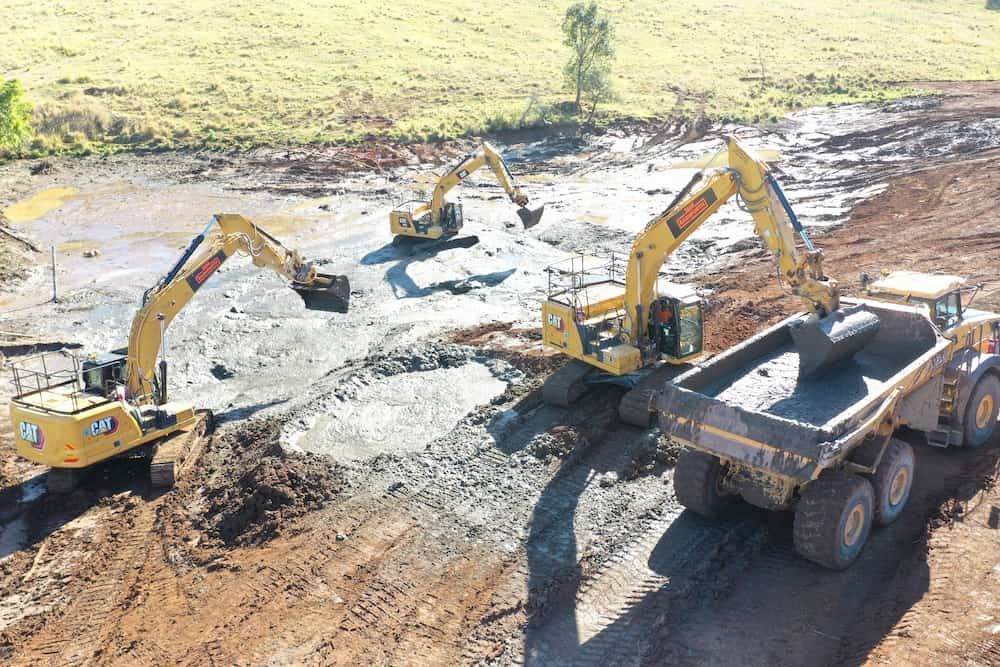 A Group Of Construction Vehicles Are Working On A Dirt Field — J & M Bashforth & Sons In Brunswick Heads, NSW