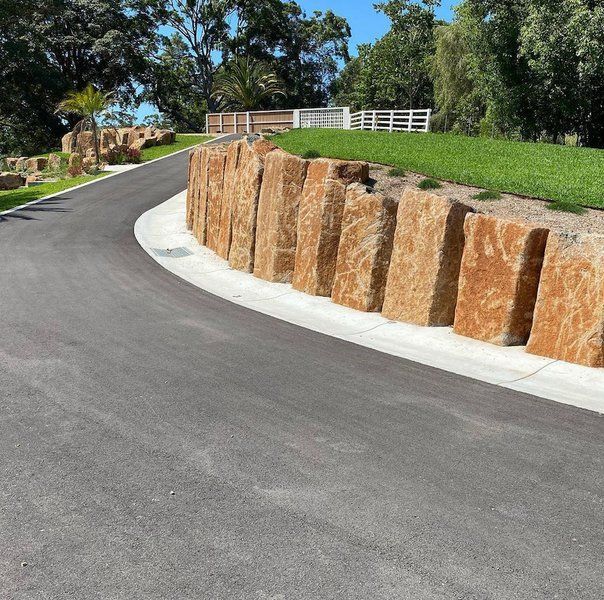 A Drive Way With A Retaining Wall To The Right— J & M Bashforth & Sons In Brunswick Heads, NSW