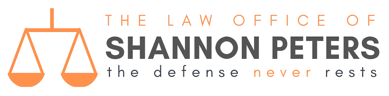 Logo of Shannon Peters Law Office with scales symbol and tagline "the defense never rests".
