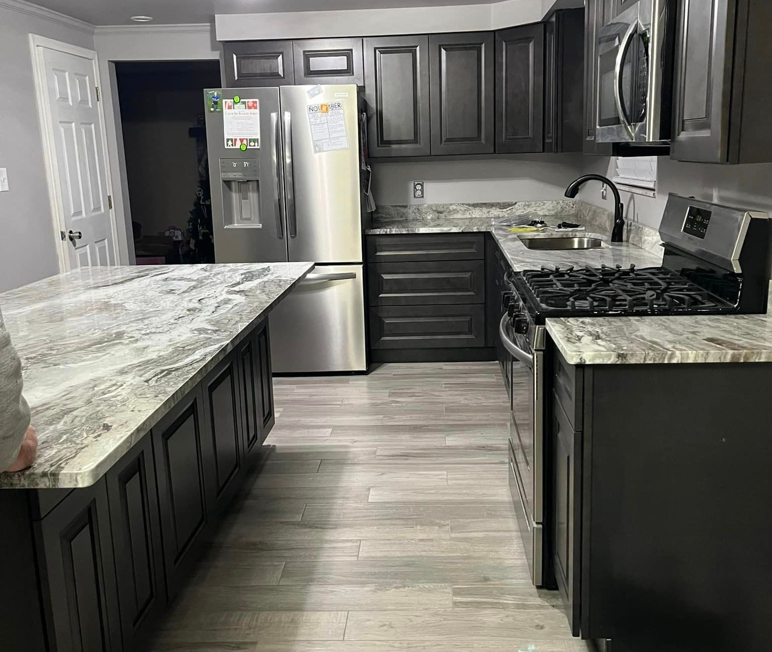 kitchen remodel with dark cabinets and marble countertops