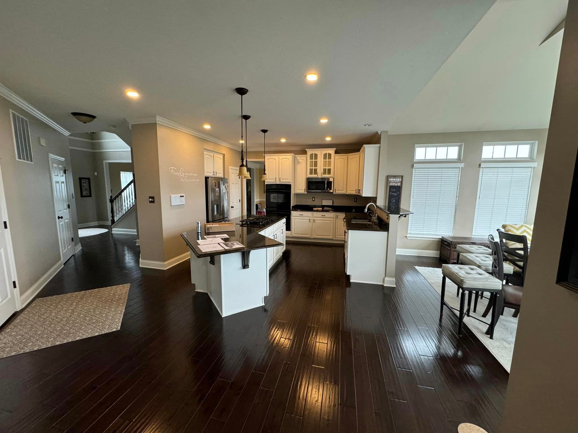 kitchen remodel after with dark wood floors and new cabinets