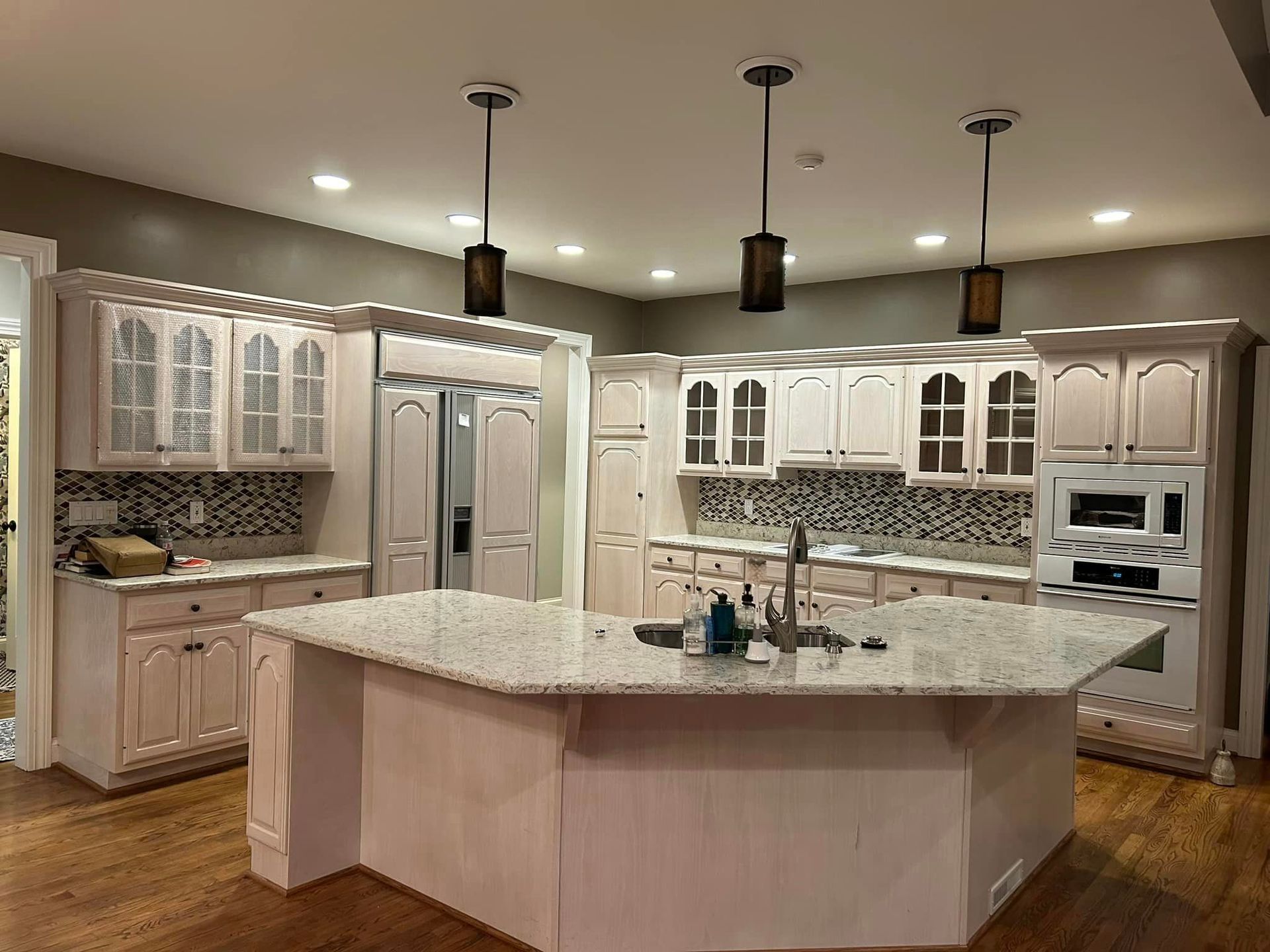 light kitchen with  different cabinets before remodeling