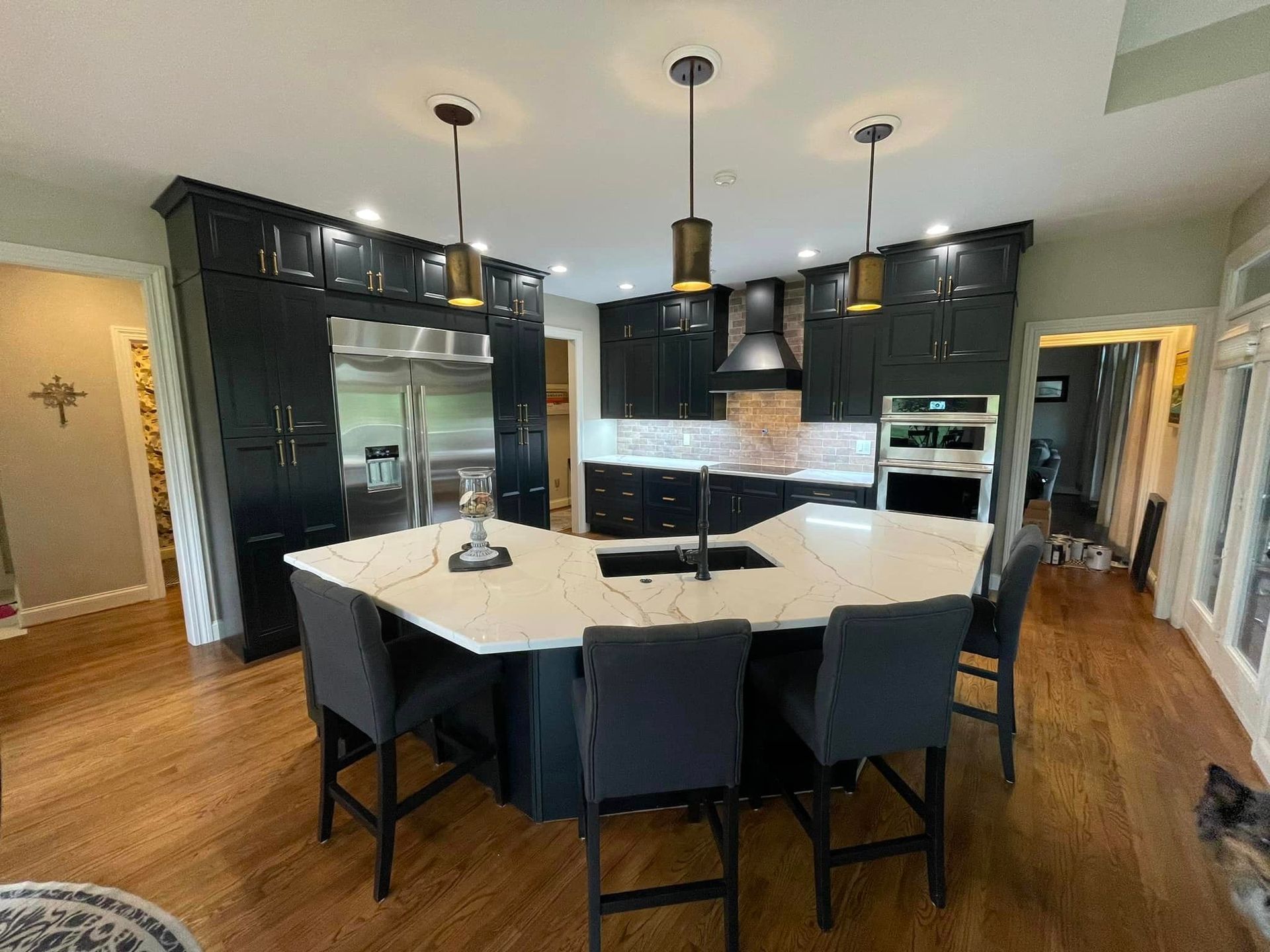 dark blue kitchen cabinets all the way to the ceiling and new countertops after kitchen remodeling