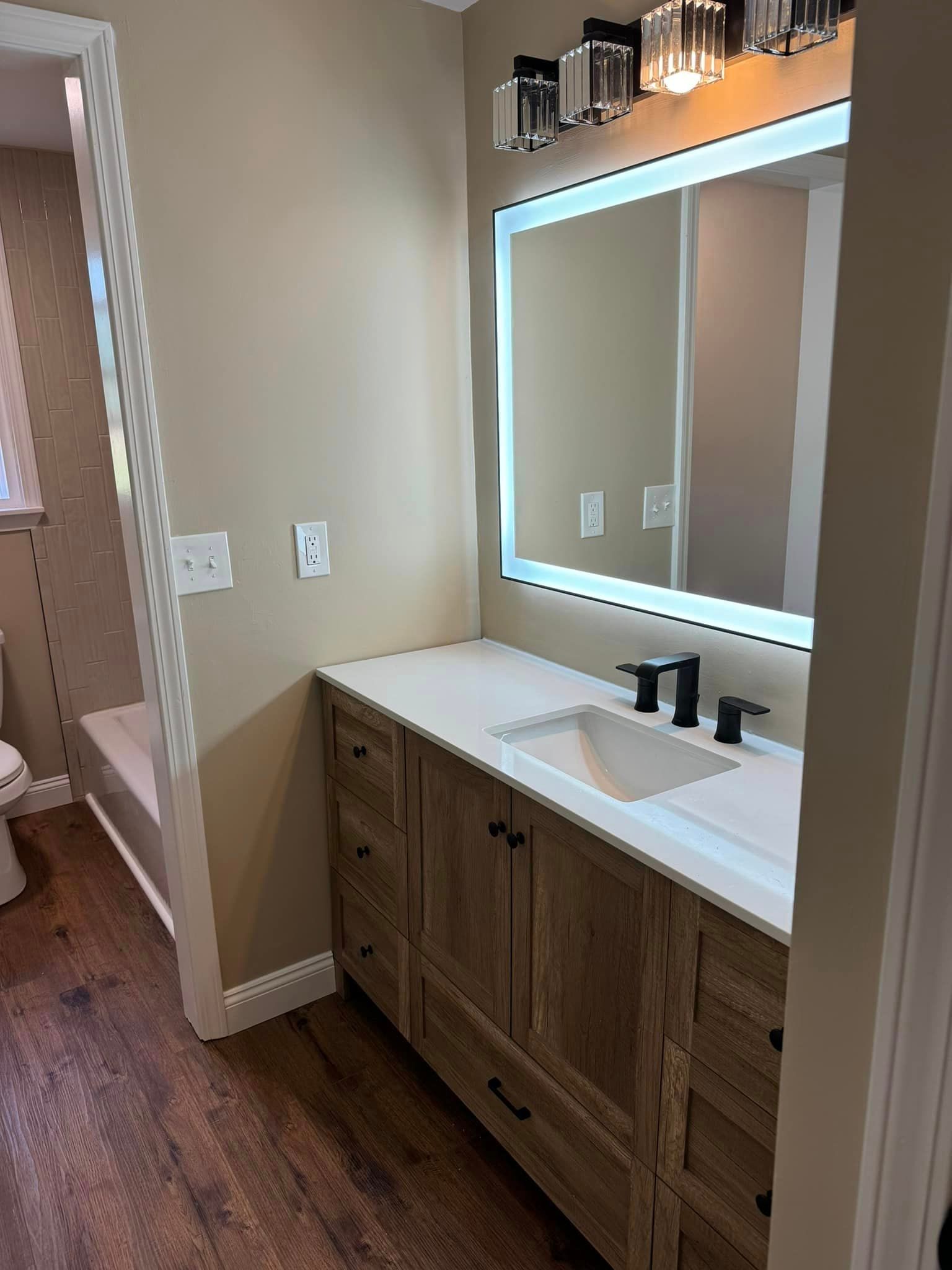 bathroom remodel with new mirror and new cabinets and sink
