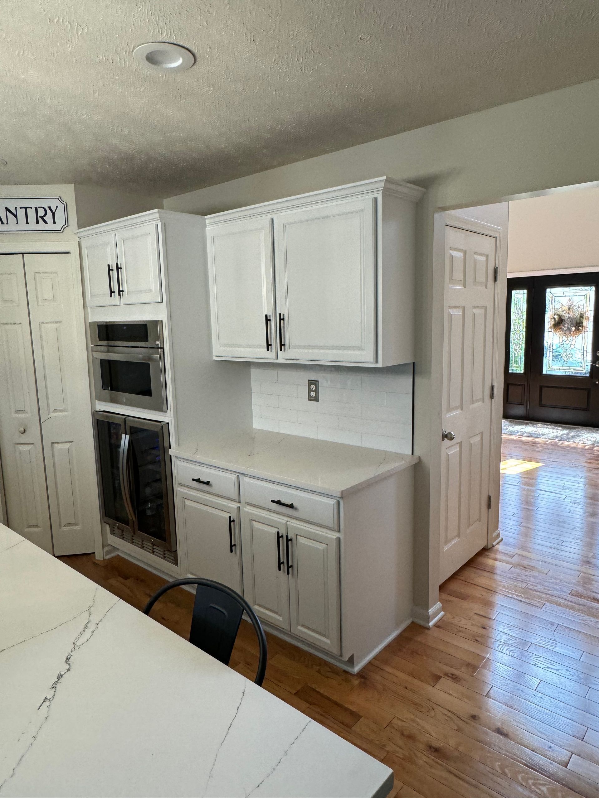 white cabinets and new stainless steel appliances after kitchen remodel