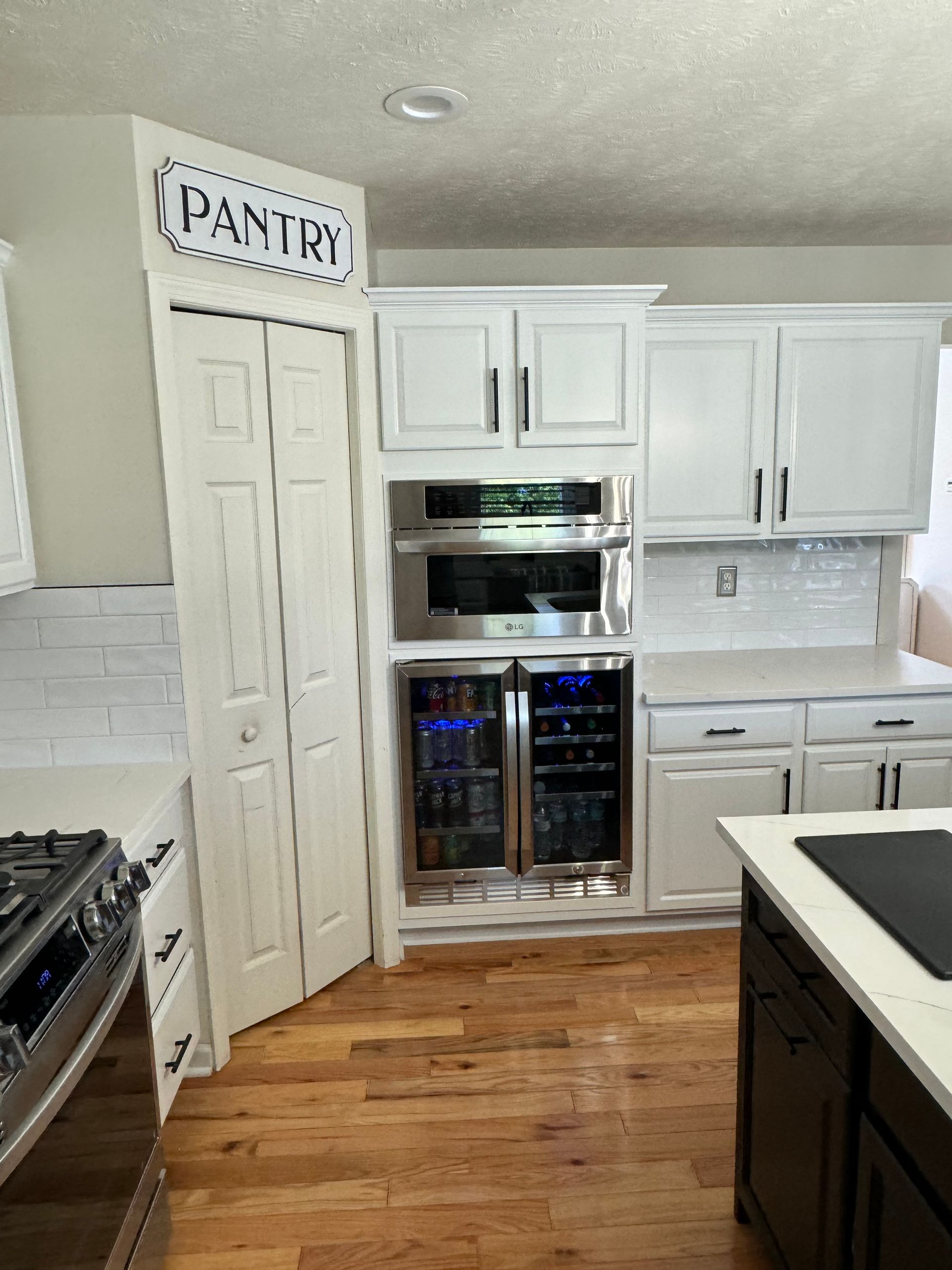 oven and beverage cooler added to kitchen along with cabinet refinishing