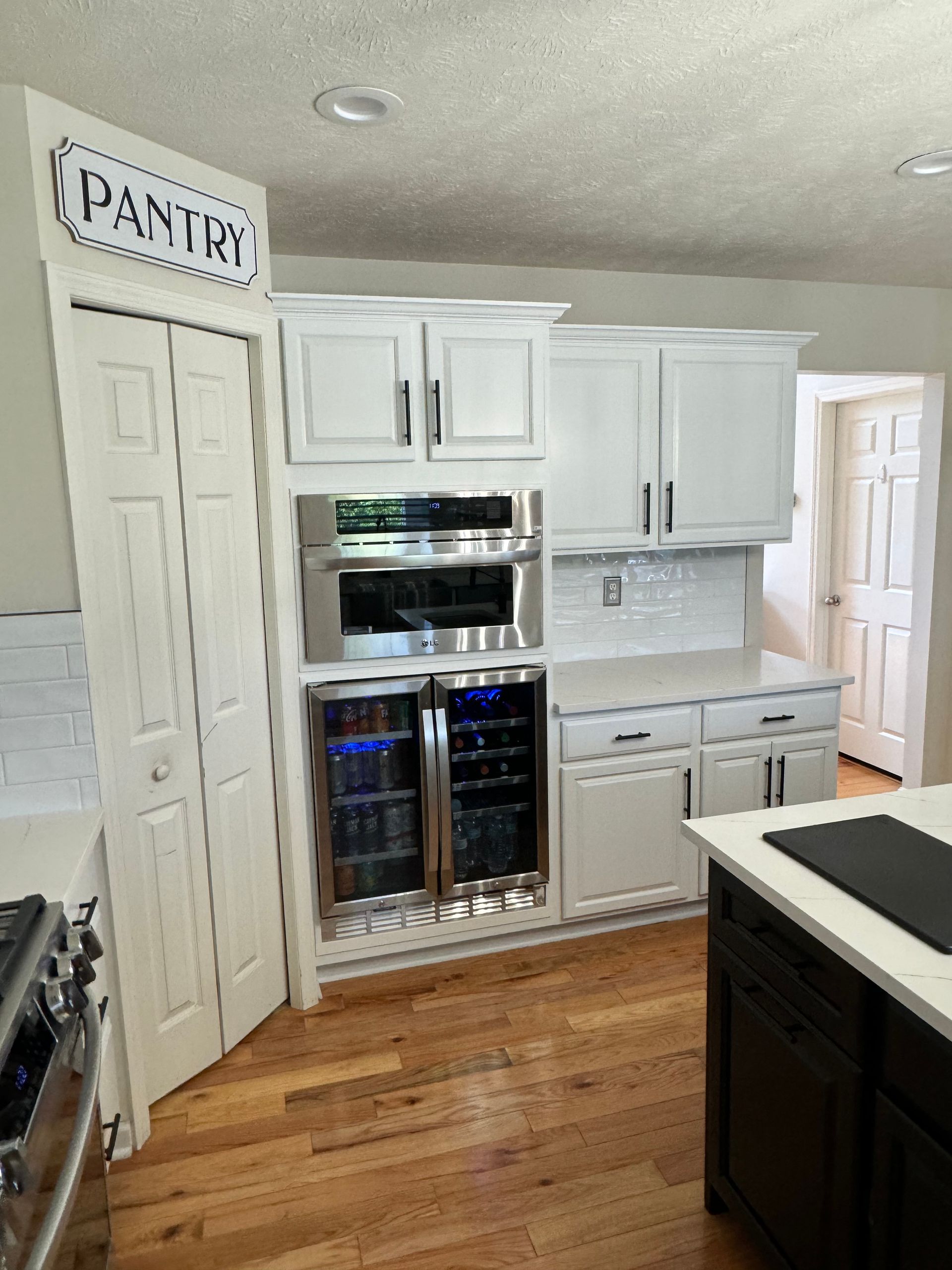 view of pantry and new stainless steel appliances. White countertops installed as a part of remodeling job in Pittsburgh