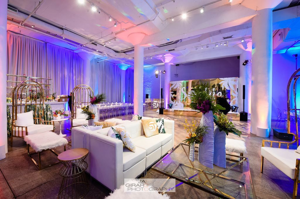 A large room filled with furniture and purple lights.