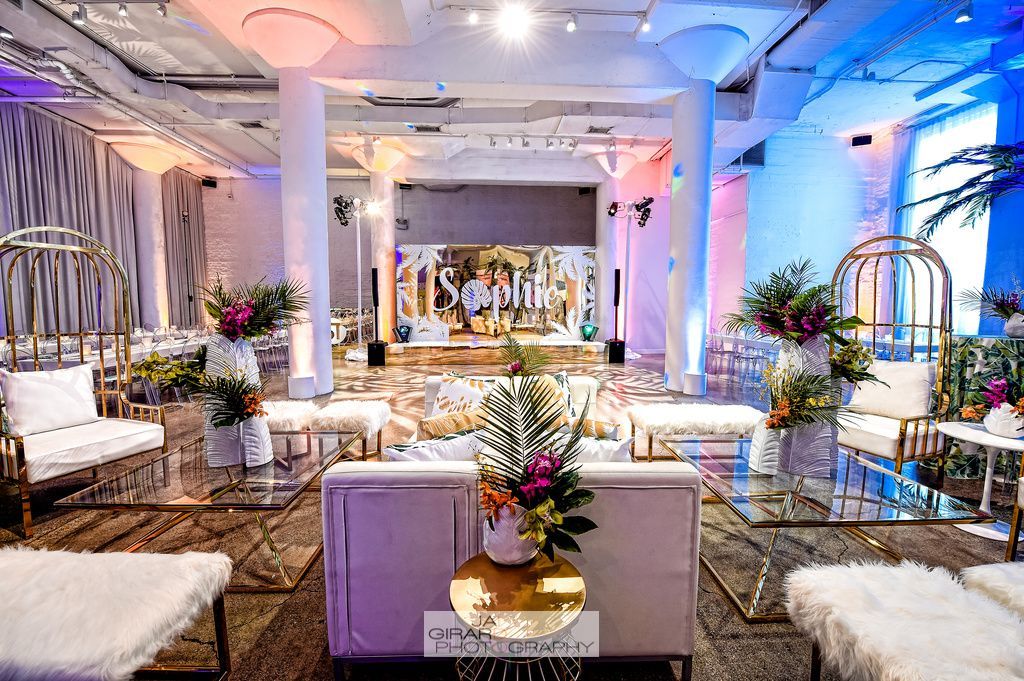 A large room with a lot of furniture and flowers on the floor.