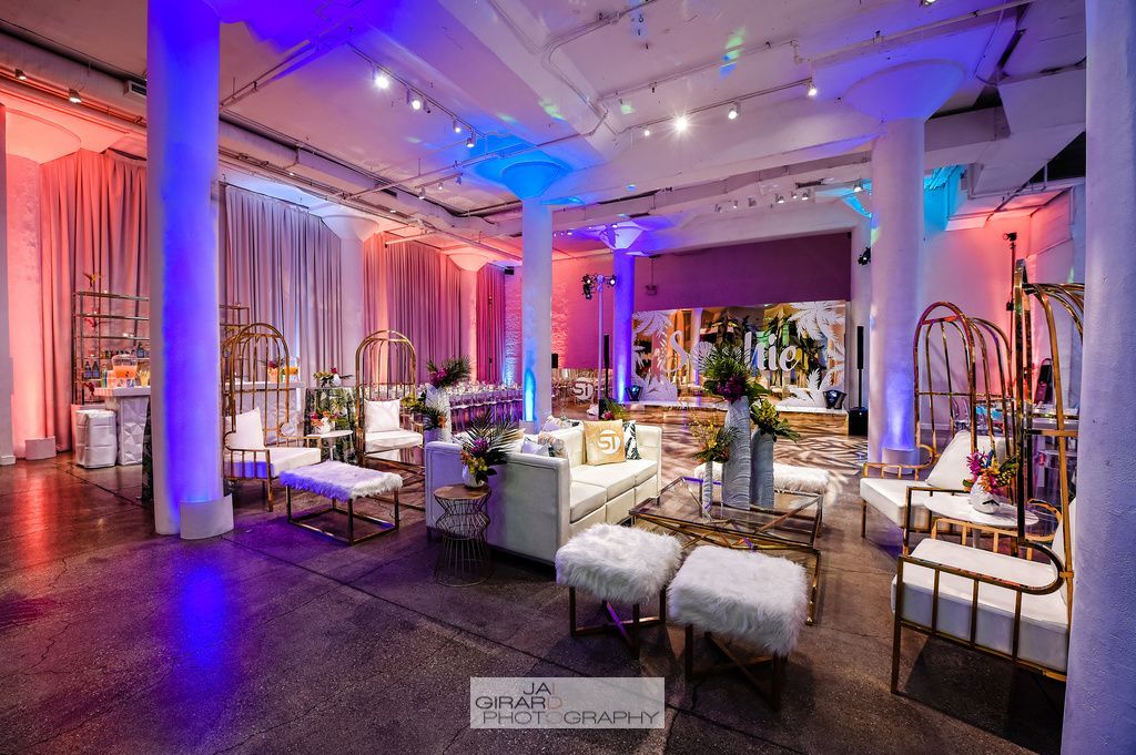 A large room filled with furniture and purple lights.