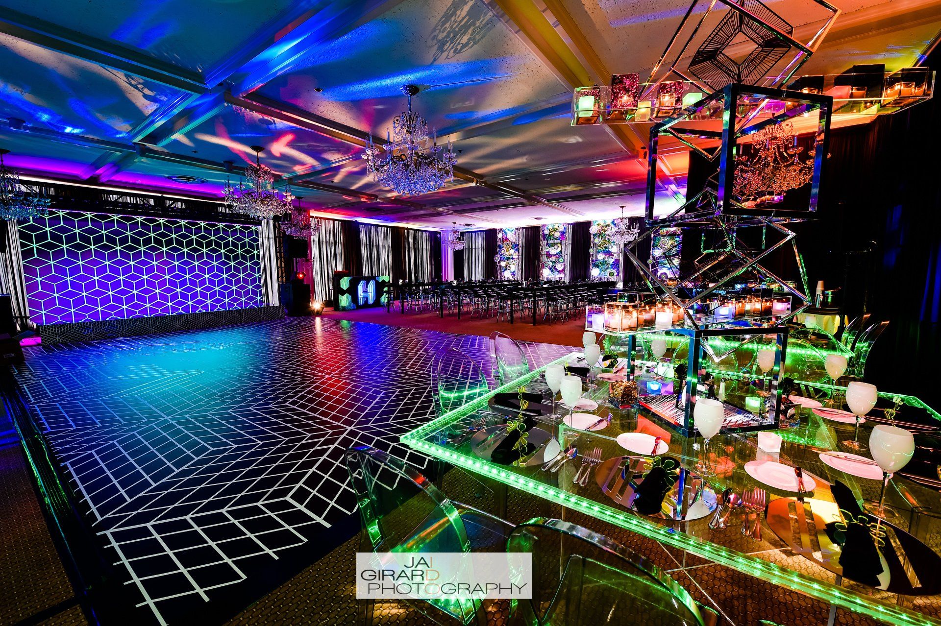 A large room with a dance floor and a table with lights on it.