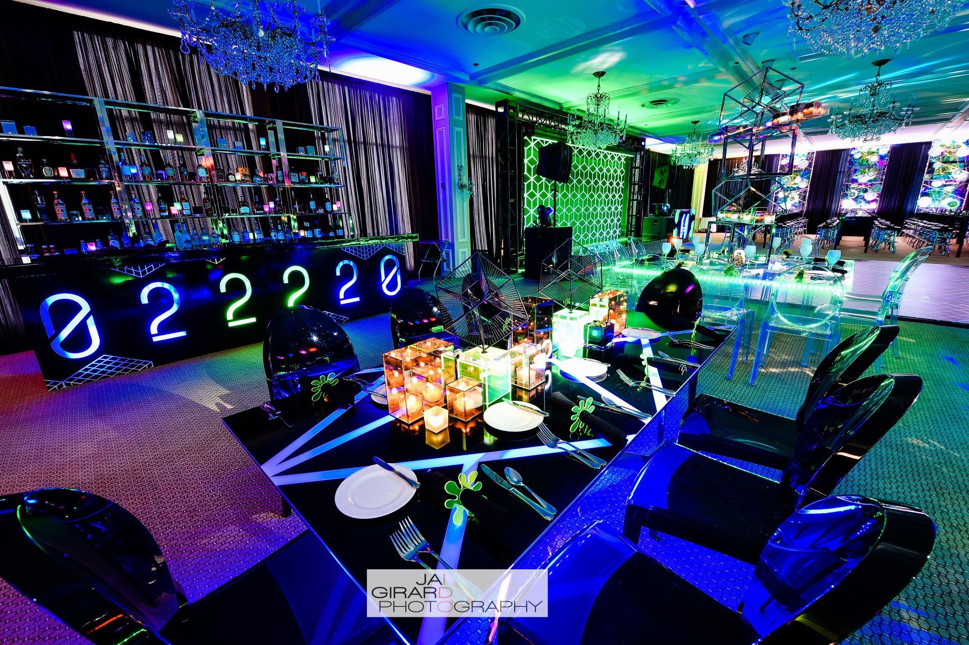 A room with a table and chairs and a neon sign that says 3228