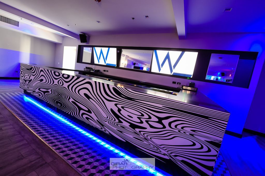 A bar with a zebra print on it and blue lights.