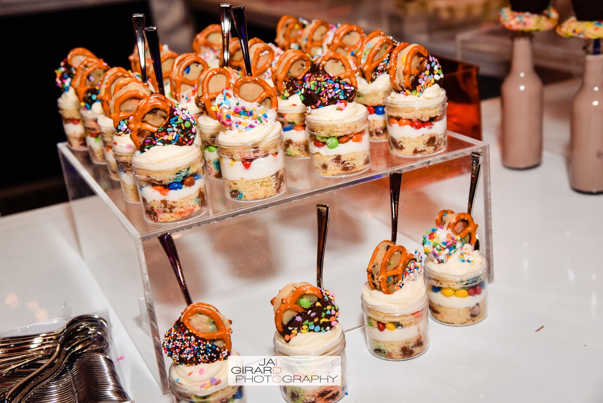 A table topped with cupcakes and pretzels on sticks.