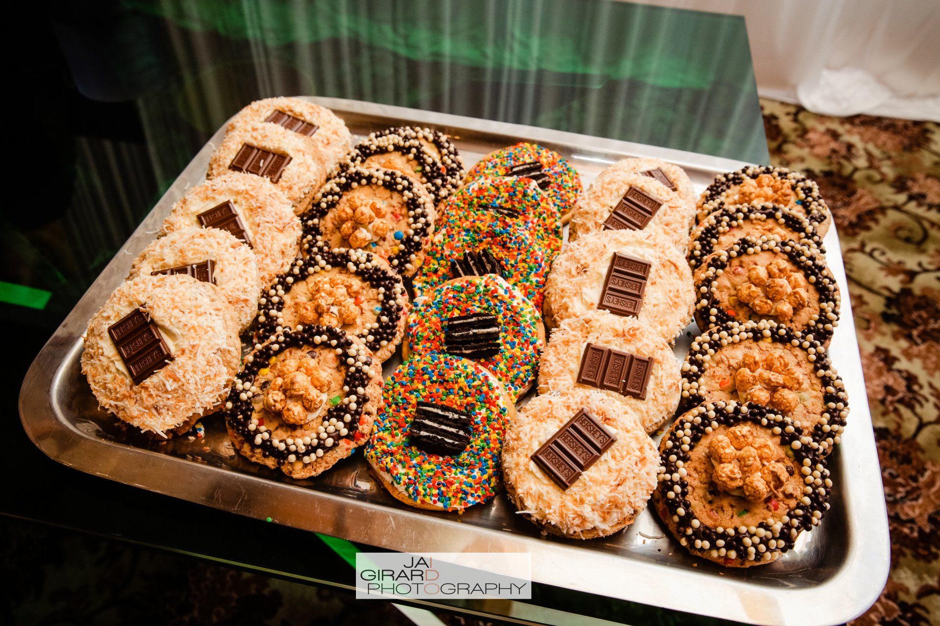 A tray of cookies with chocolate and sprinkles on them