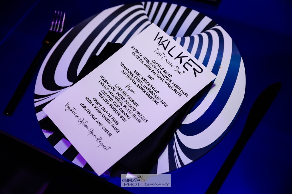 A black and white striped plate with the word walker on it