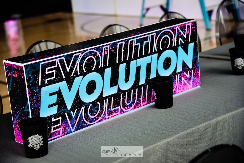 A sign that says evolution is on a table