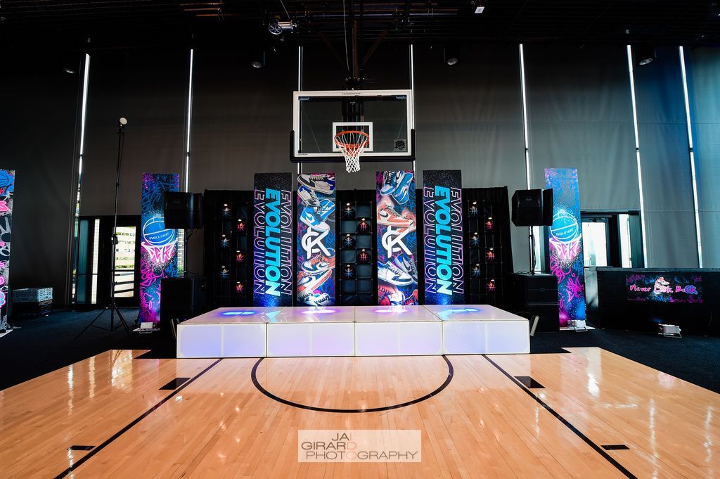 A basketball court with a stage in the middle of it.