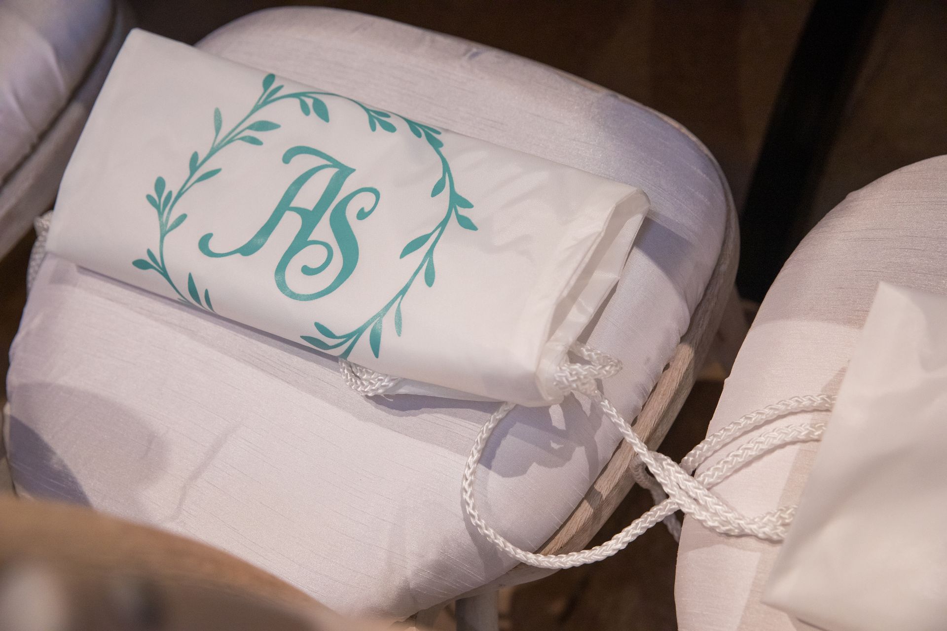 A white towel with the letters hs embroidered on it