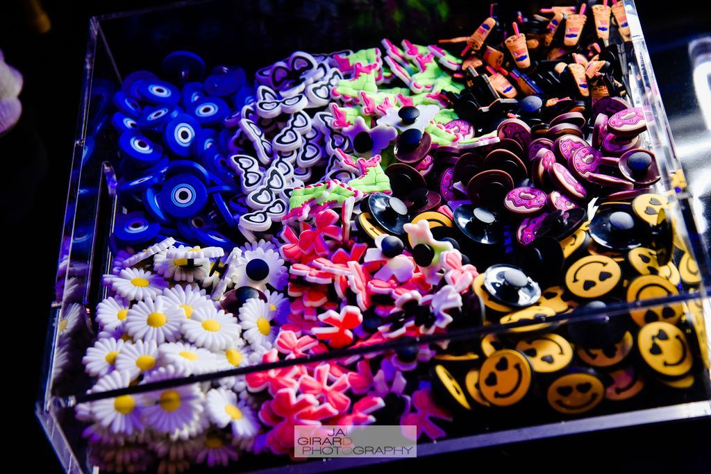 A box filled with different colored flowers and buttons