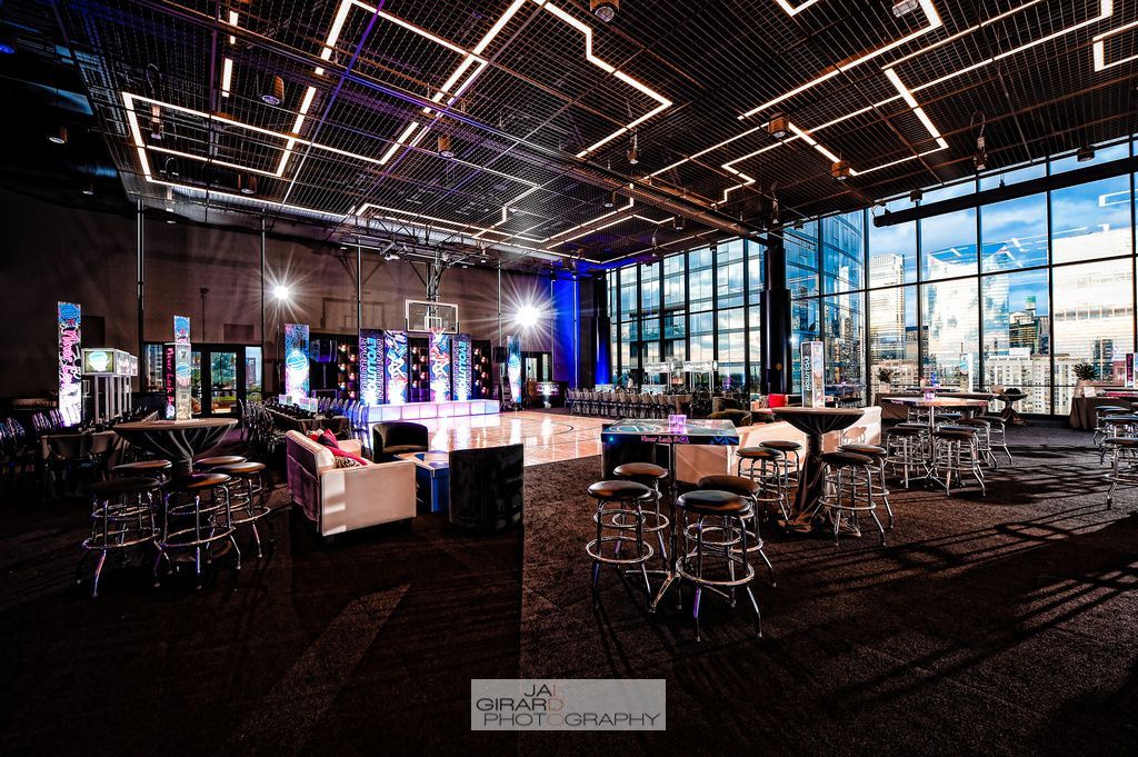 A large room with tables and chairs and a dance floor.