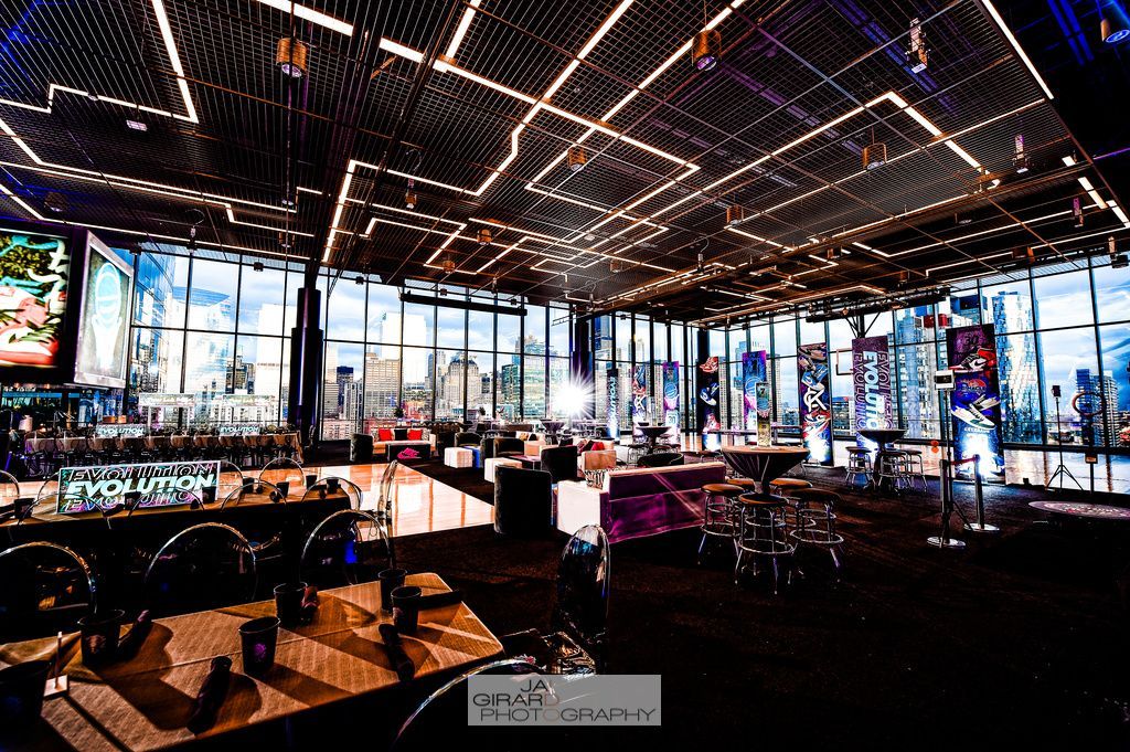 A large room with a lot of tables and chairs in it.