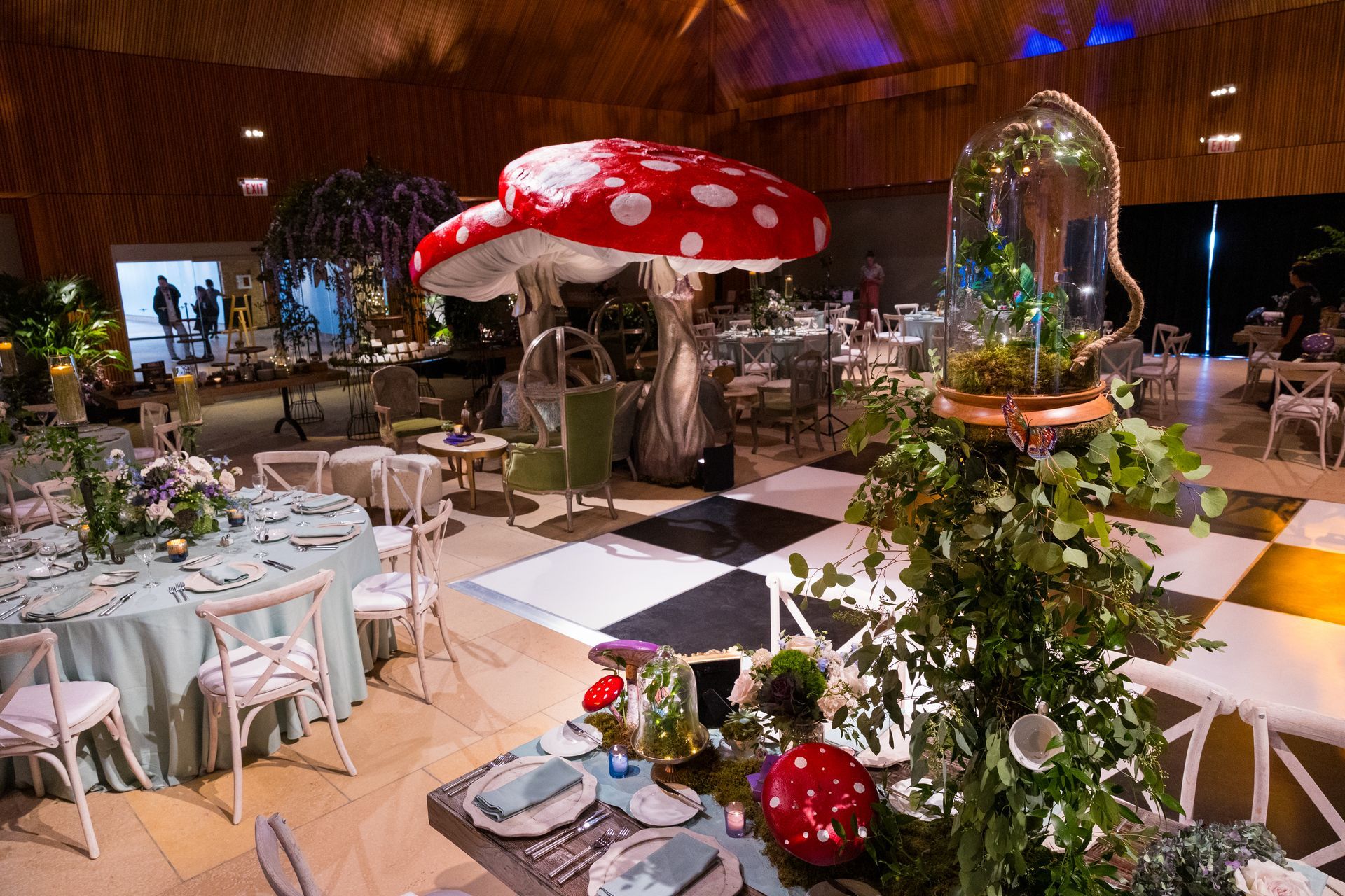A large room filled with tables and chairs and a large mushroom.