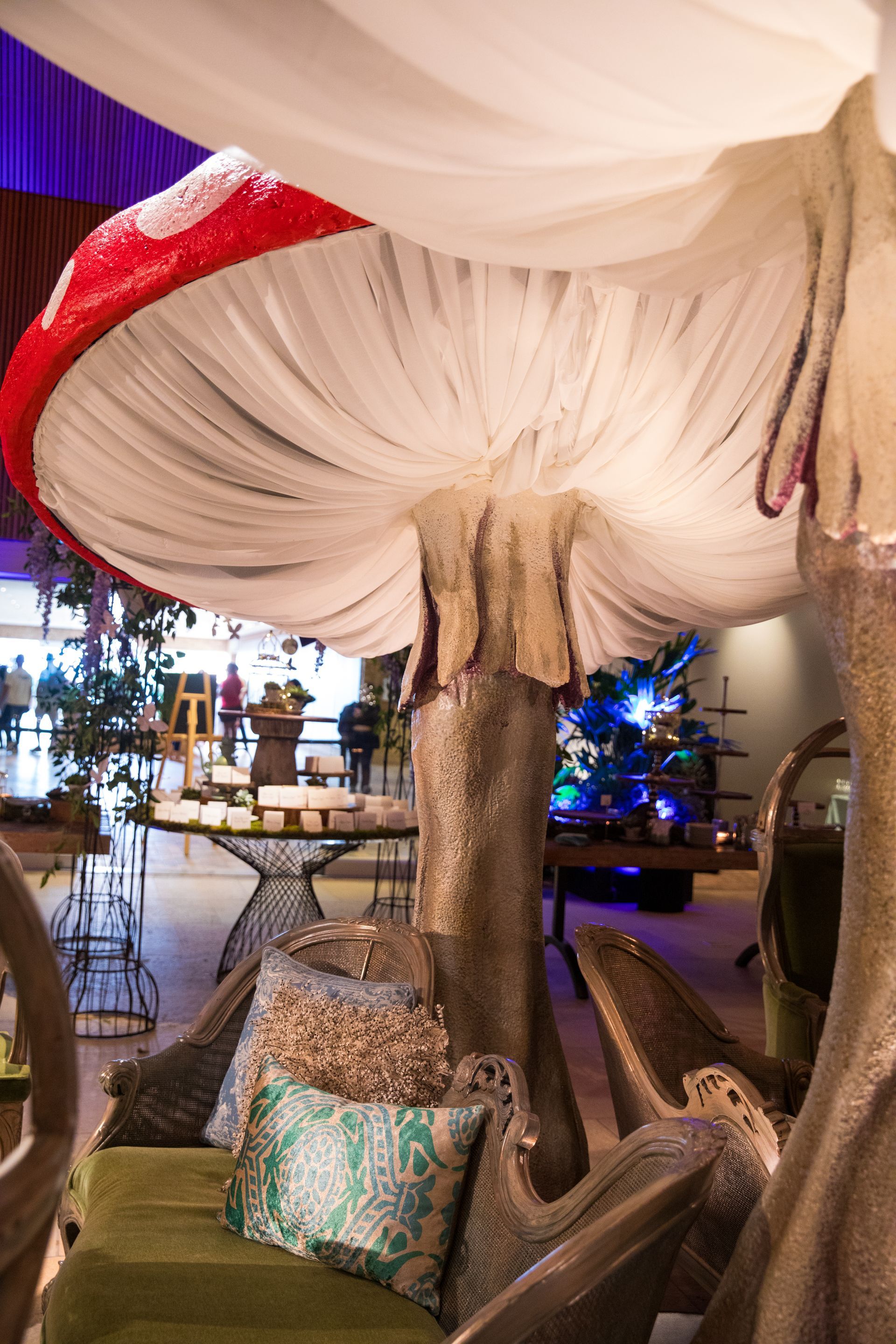 A large mushroom is hanging from the ceiling of a room.