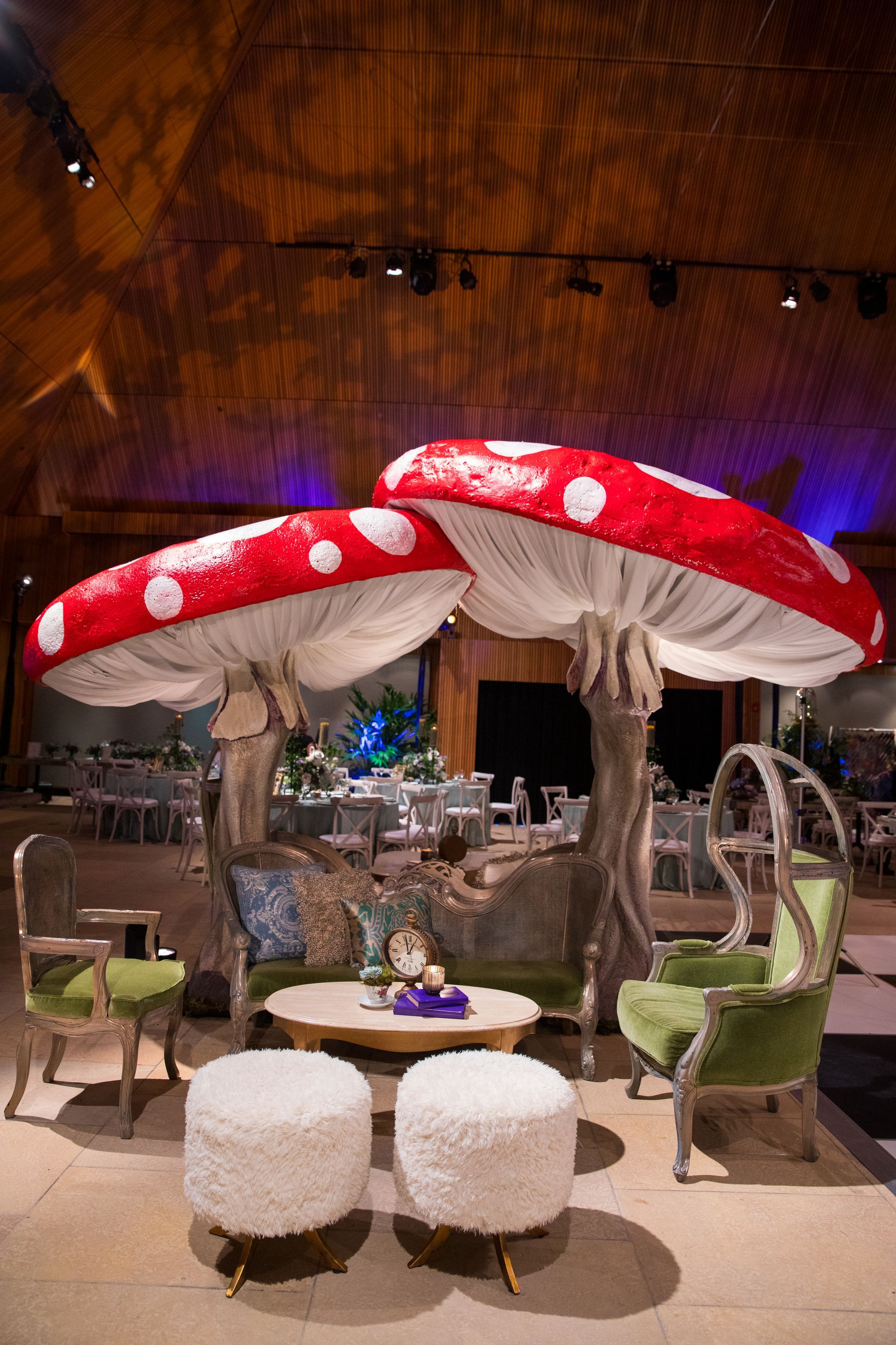 Two giant mushrooms are sitting on top of a table in a room.