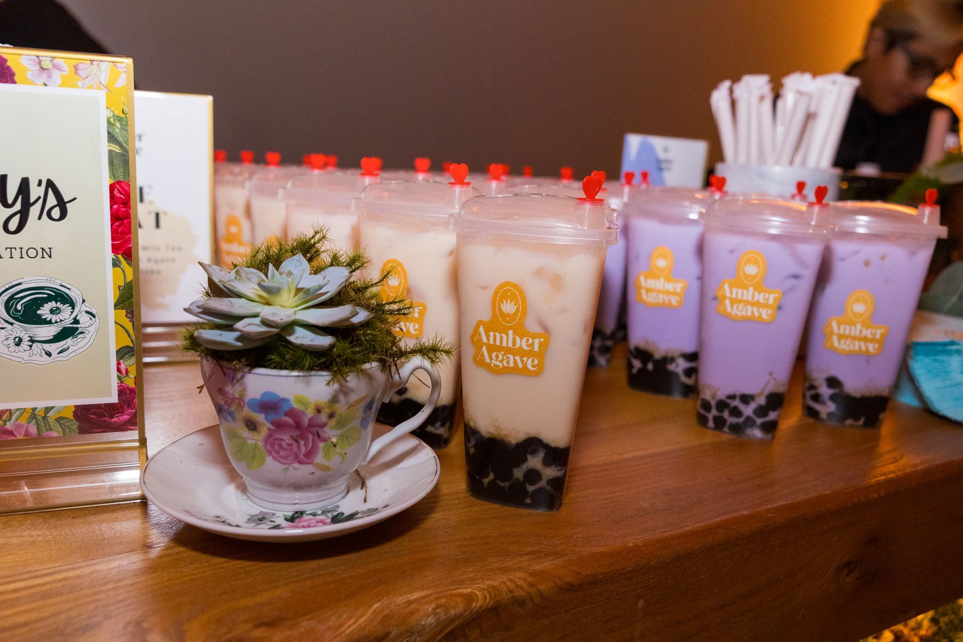 A table topped with a variety of drinks and a plant.